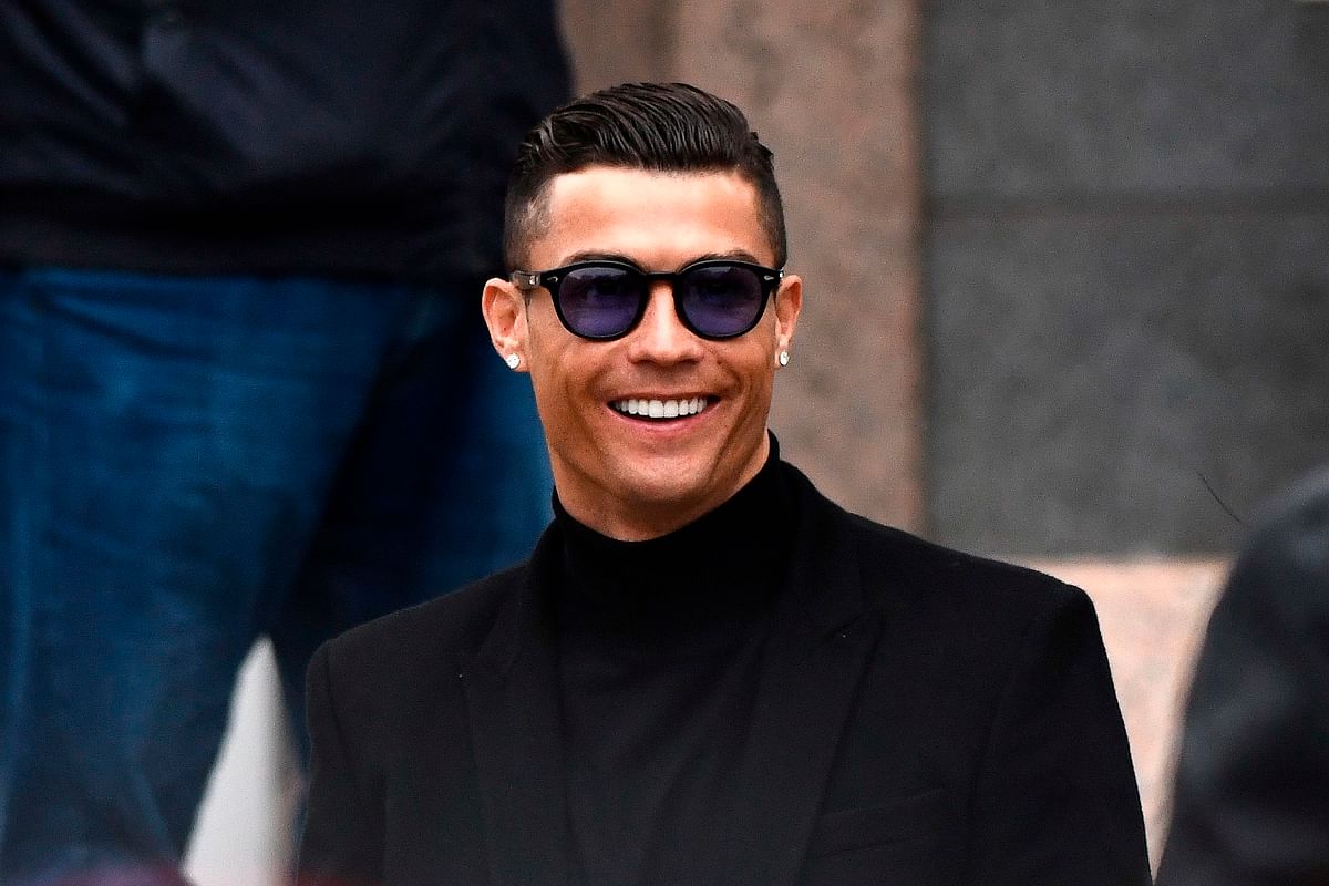 In this file photo taken on 22 January 2019 Juventus` forward and former Real Madrid player Cristiano Ronaldo smiles as he leaves after attending a court hearing for tax evasion in Madrid. Photo: AFP