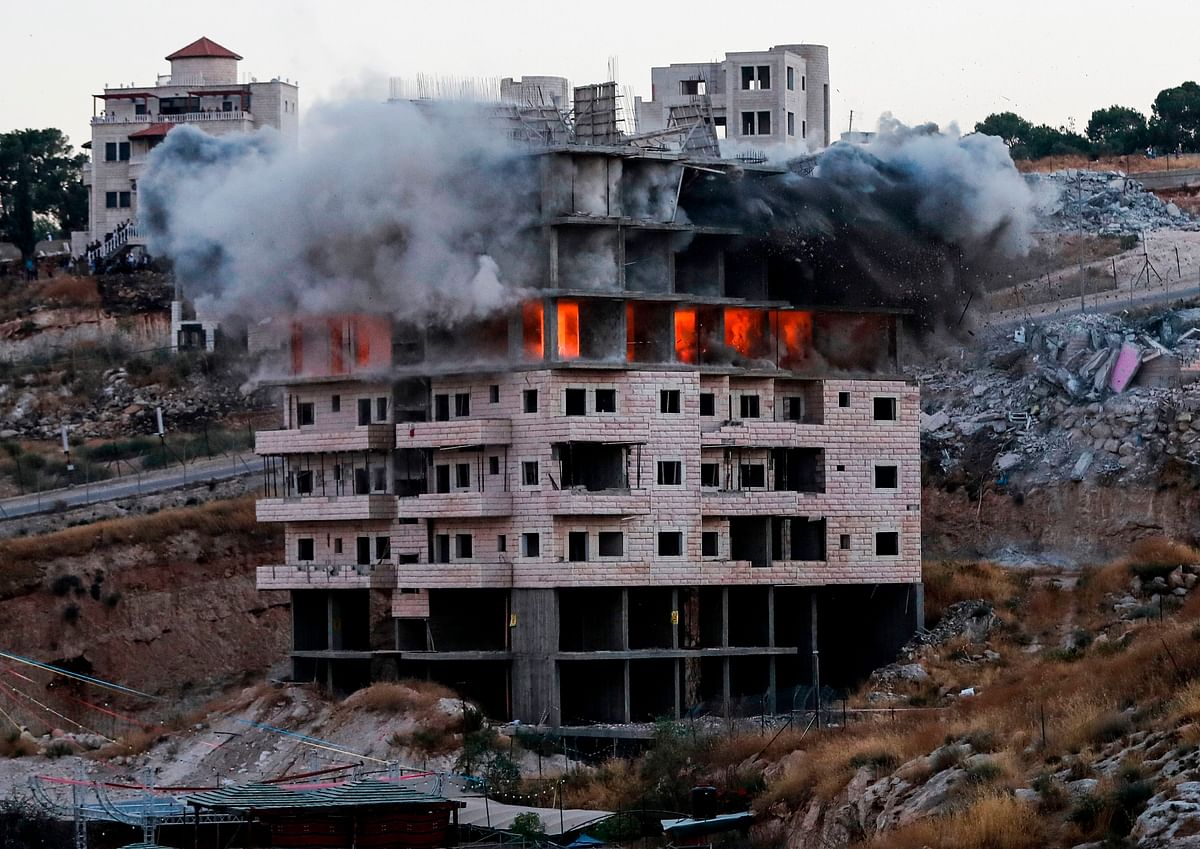 This picture taken on 22 July, 2019, shows the demolition of a Palestinian building which was under construction, in the the Palestinian village of Sur Baher in East Jerusalem. Israel demolished a number of Palestinian homes it considers illegally constructed near its separation barrier south of Jerusalem on 22 July, in a move that drew international condemnation. Photo: AFP