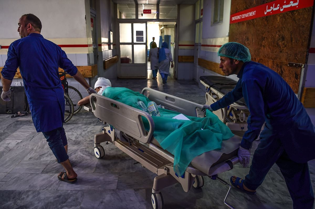 An injured man is brought on a stretcher as he receives treatment at the Wazir Akbar Khan hospital following three blasts in Kabul on 25 July 2019. Photo: AFP