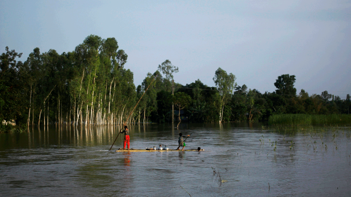 In this photograph taken on 25 July, 2019, residents travel on a makeshift raft to collect drinking water in a flood affected area following monsoon rain in Kurigram district. Photo: AFP
