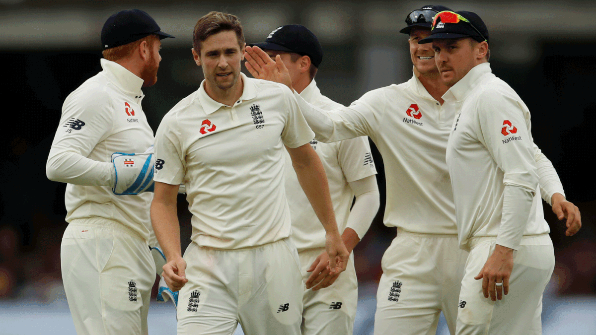 England`s Chris Woakes celebrates with team mates after taking the wicket of Ireland`s Paul Stirling. Photo: Reuters