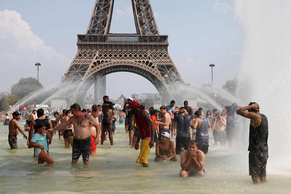 People cool off in the Trocadero fountains across from the Eiffel Tower in Paris. Photo: Reuters