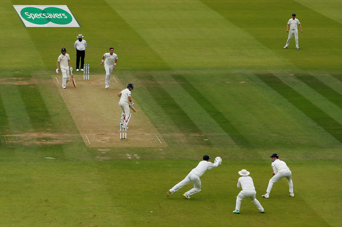 Ireland`s Mark Adair takes a catch to dismiss England`s Joe Root off the bowling of Gary Wilson in the only Test Match between England and Ireland at Lord`s Cricket Ground, London, Britain on 25 July 2019. Photo: Reuters