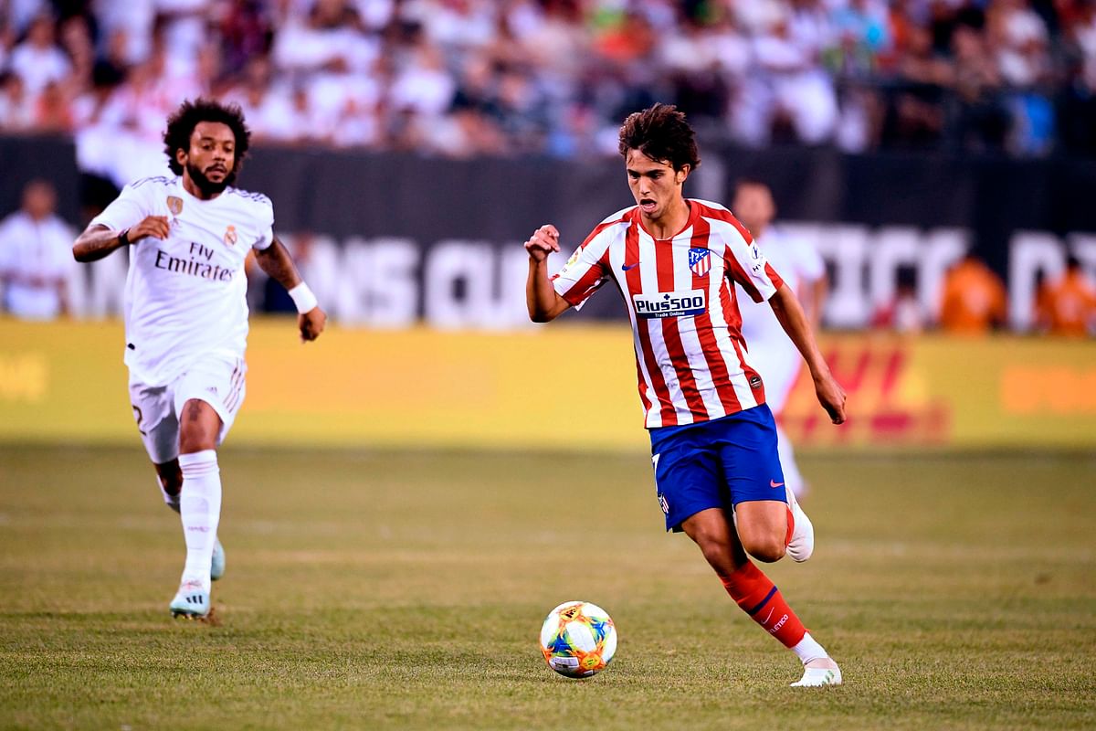 Real Madrid`s Brazilian defender Marcelo (L) runs after Atletico Madrid`s Portuguese midfielder Joao Felix as he controls the ball during their 2019 International Champions Cup football match between Real Madrid and Atletico Madrid at the Metlife Stadium Arena in East Rutherford, New Jersey on 26 July 2019. Photo: AFP