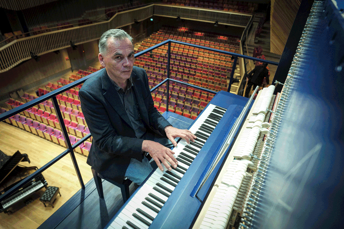 Piano constructor and builder David Klavins plays his new creation, the M470i vertical concert grand piano, with a height of 4,70 meters, at the new `Lativa` concert hall in Ventspils, Latvia, on 23 July, 2019. Photo: AFP