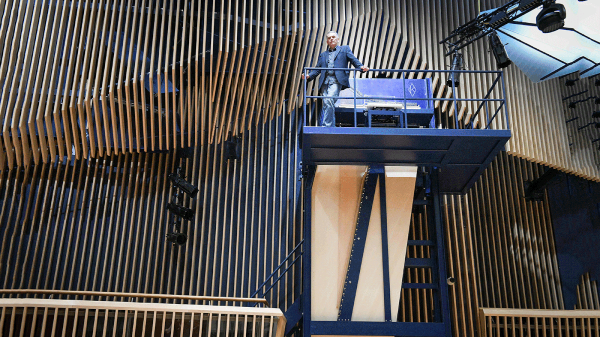 Piano constructor and builder David Klavins stands next to his new creation, the M470i vertical concert grand piano, with a height of 4,70 meters, at the new `Lativa` concert hall in Ventspils, Latvia, on 23 July, 2019. Photo: AFP