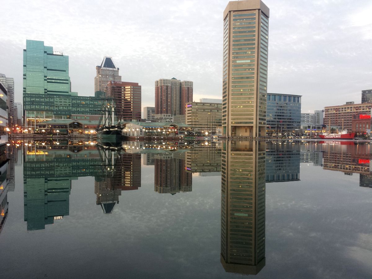 This file photo taken on 31 January 2014, shows Baltimore, Maryland, is reflected in a still and icy Inner Harbour. Photo: AFP