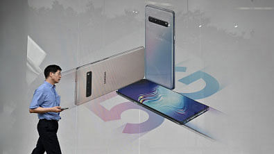 A man walks past an advertisement for the Samsung Galaxy S10 5G smartphone in Seoul on 31 July 2019. The world`s biggest smartphone and memory chip maker Samsung Electronics on 31 July, reported second quarter net profits slumping by more than half in the face of a weakening chip market, and as a trade row builds between Seoul and Tokyo. Photo: AFP