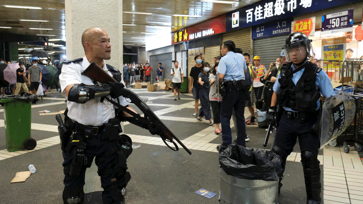 Police officers react during clashes with anti-extradition bill protesters who surrounded a police station where detained protesters are being held in Hong Kong, China on 30 July 2019. Photo: Reuters