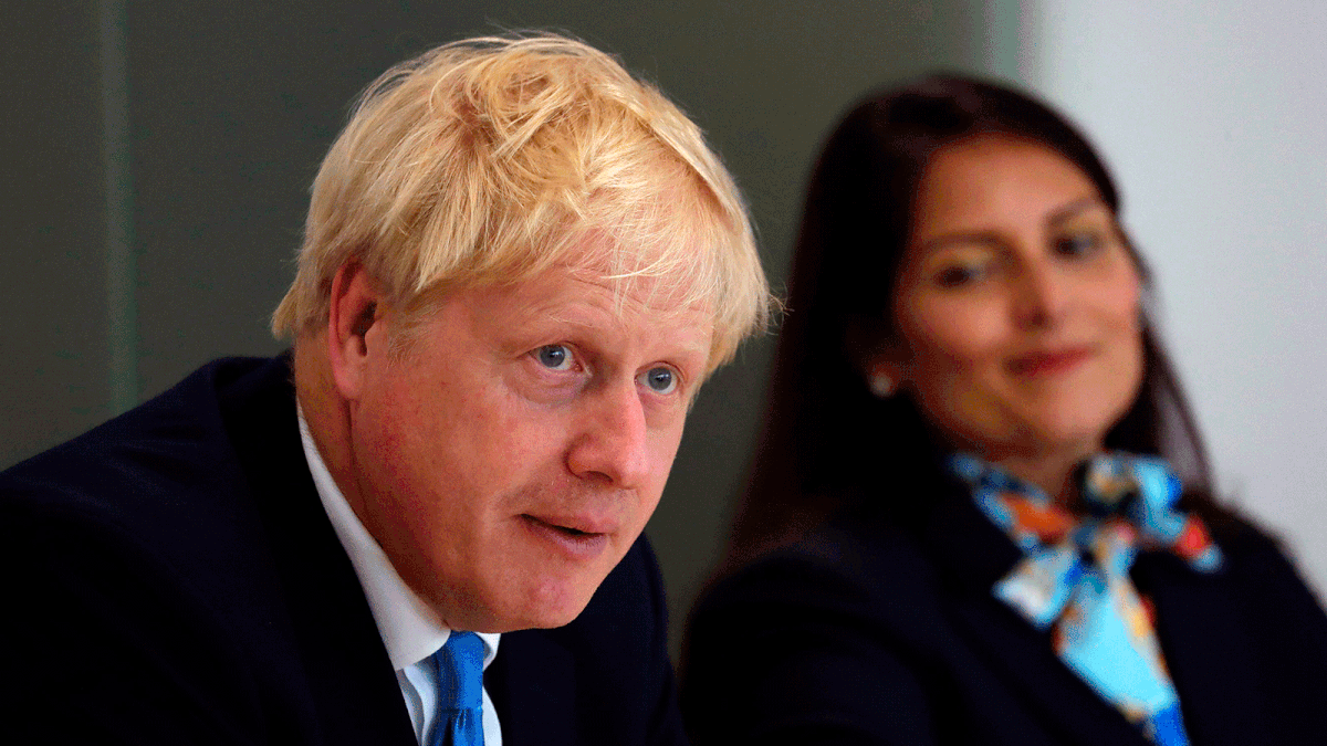 Britain`s prime minister Boris Johnson, accompanied by Britain`s home secretary Priti Patel, speaks at the first meeting of the National Policing Board at the Home Office in London, on 31 July. Photo: AFP