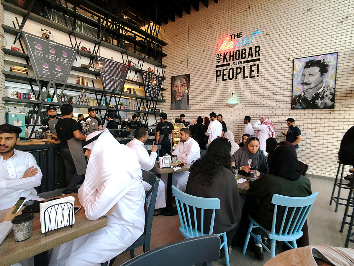 Women sit among men in a newly opened cafe in Khobar, Saudi Arabia, on 2 August 2019. Photo: Reuters
