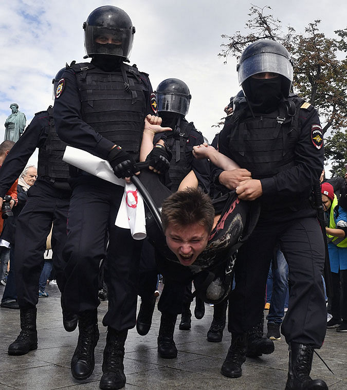 Riot police officers detain a participant of an unsanctioned rally urging fair elections at Moscow`s Pushkinskaya Square on 3 August. Photo: AFP