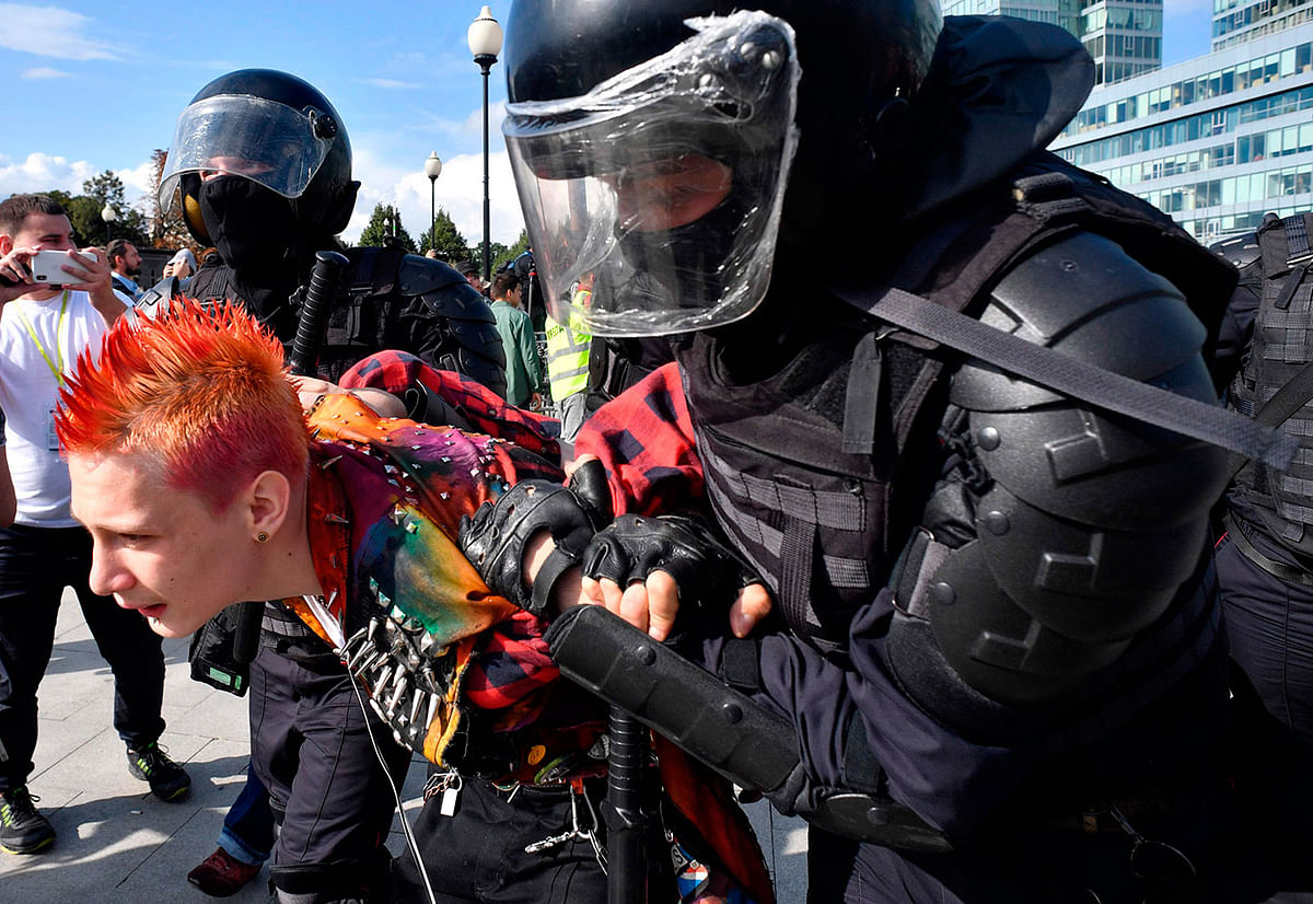 Riot police officers detain a man during an unsanctioned rally urging fair elections in downtown Moscow on 3 August. Photo: AFP