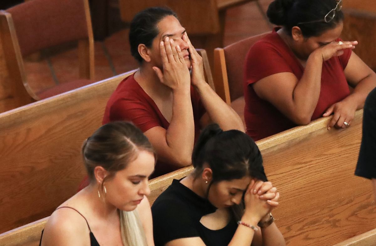 Women react at the conclusion of a vigil at St Pius X Church, held for victims after a mass shooting which left at least 20 people dead, on August 3, 2019 in El Paso, Texas. A 21-year-old male suspect was taken into custody. Photo: AFP