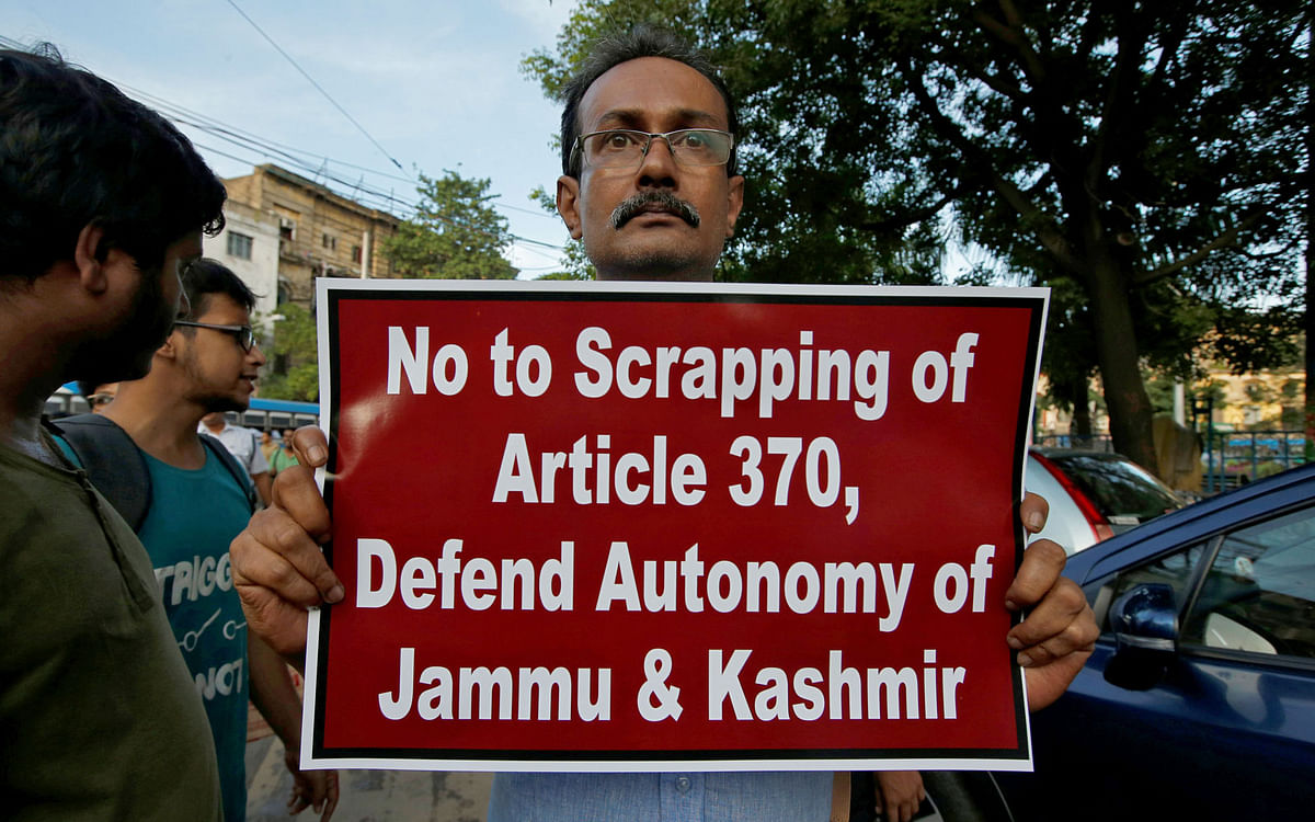 A man displays a placard during a protest against the scrapping of special constitutional status for Kashmir, in Kolkata, India, on 6 August 2019. Photo: Reuters