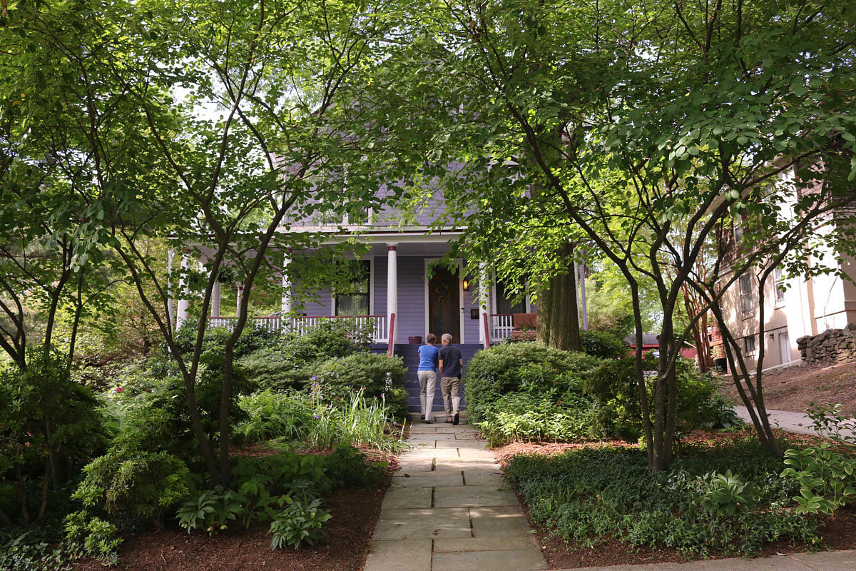In this file photo taken on 22 May 2019 Anna Burger (L) and Earl Gohl (R) walk in their `rewilded` garden, a type of garden aimed at restoring and protecting natural processes in Takoma Park, Maryland. Photo: AFP