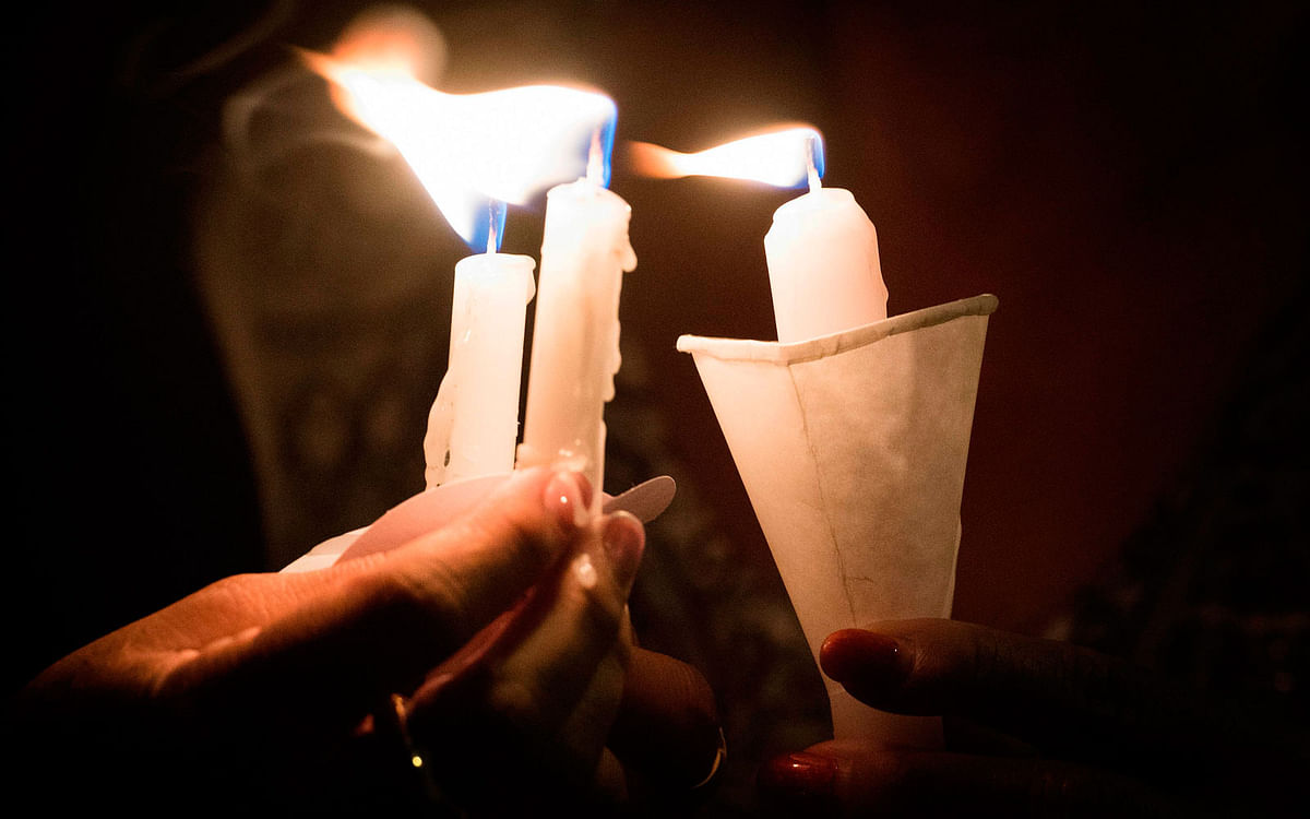 People hold candles as they pray during a candlelight vigil at the Immanuel Church for victims of a shooting that left a total of 22 people dead at the Cielo Vista Mall WalMart in El Paso, Texas, on 5 August 2019. Photo: AFP