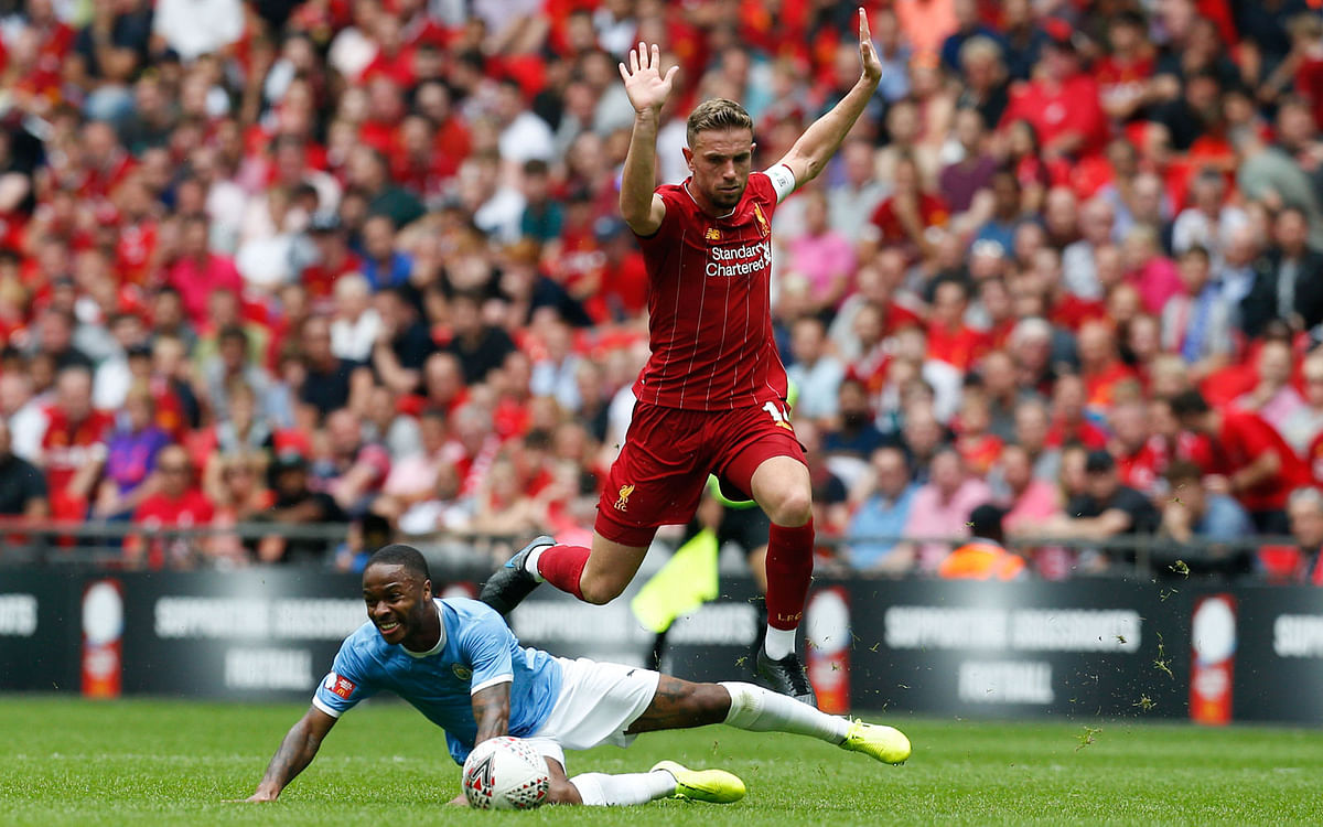 Manchester City`s English midfielder Raheem Sterling (L) challenges Liverpool`s English midfielder Jordan Henderson (R) during the English FA Community Shield football match between Manchester City and Liverpool at Wembley Stadium in north London on 4 August 2019. Photo: AFP