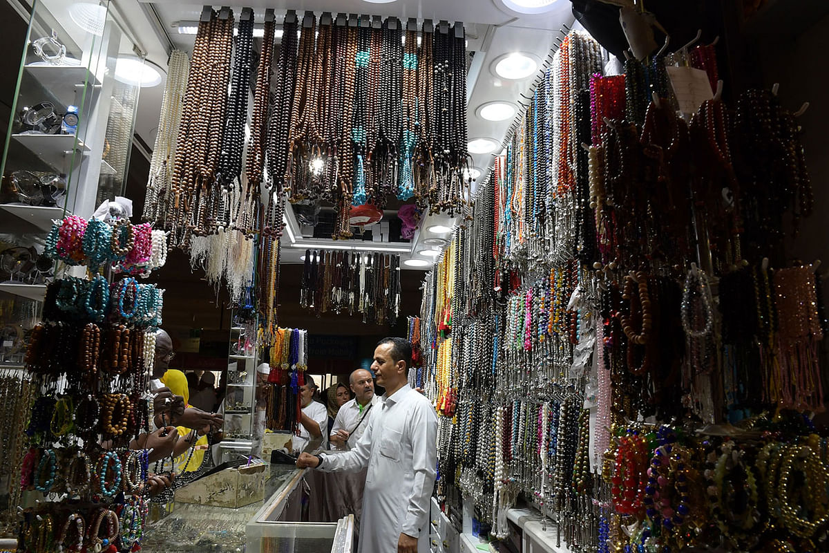 Muslim pilgrims choose prayer beads at a shop in the Saudi holy city of Mecca on 6 August 2019, a few days ahead of the annual Hajj pilgrimage. Muslims from across the world gather in Mecca in Saudi Arabia for the annual six-day pilgrimage, one of the five pillars of Islam. Photo: AFP