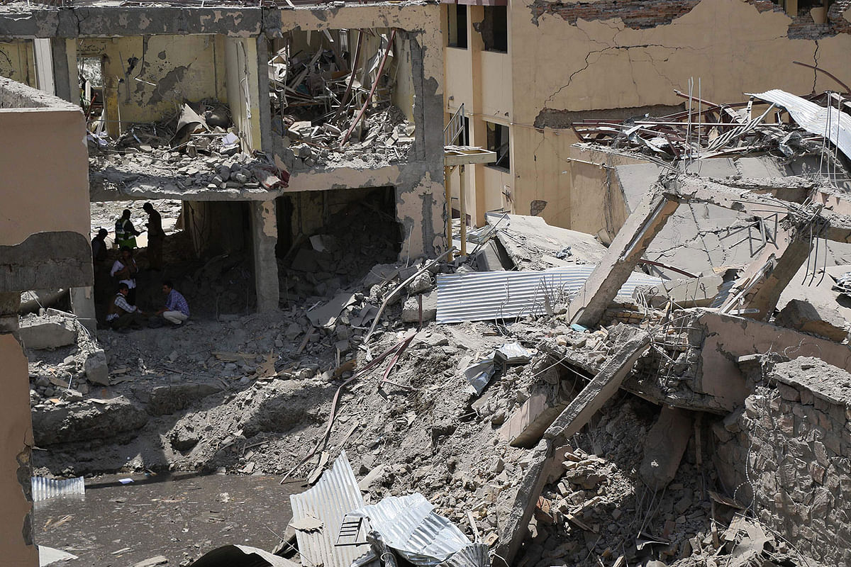 Afghan security forces investigate the site where a Taliban car bomb detonated at the entrance of a police station in Kabul on 7 August 2019. Photo: AFP