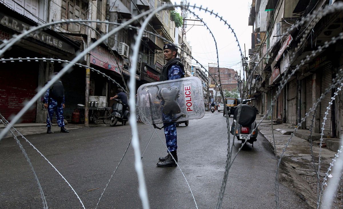 Rapid Action Force personnel stand guard at a roadblock ahead of the Muslim Friday noon prayers in Jammu on 9 August, 2019, after the Indian government stripped Jammu and Kashmir of its autonomy. Photo: AFP