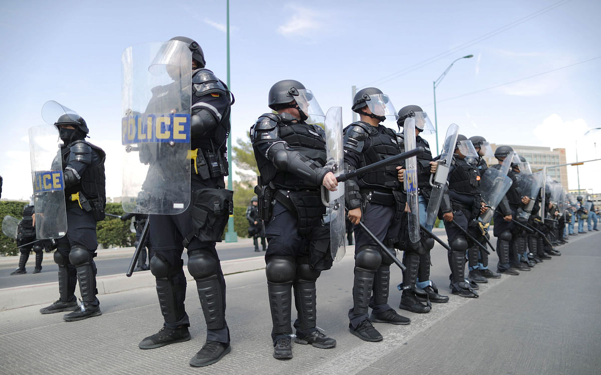 Riot police line up near protestors outside University Medical Center, where President Trump was visiting shooting victims, following a mass shooting which left at least 22 people dead, on 7 August 2019 in El Paso, Texas. Photo: AFP