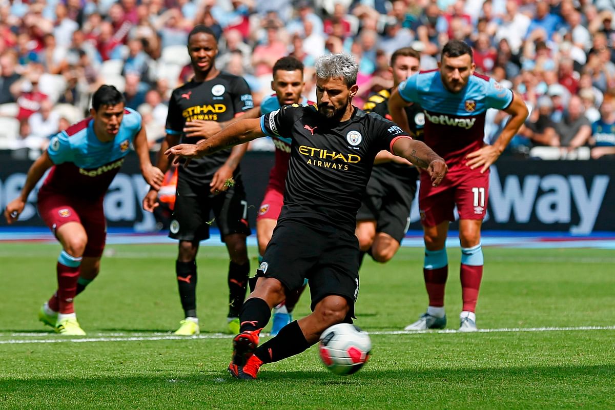 Manchester City`s Argentinian striker Sergio Aguero strikes the ball to score from the penalty spot for Manchester City`s fourth goal during the English Premier League football match between West Ham United and Manchester City at The London Stadium, in east London on 10 August, 2019. Photo: AFP