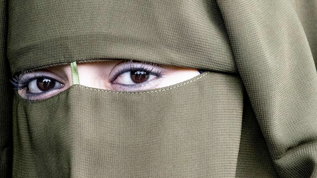 A woman wearing a niqab takes part in a demonstration against the ban of a face-covering veil, in The Hague on 9 August 2019. Photo: AFP