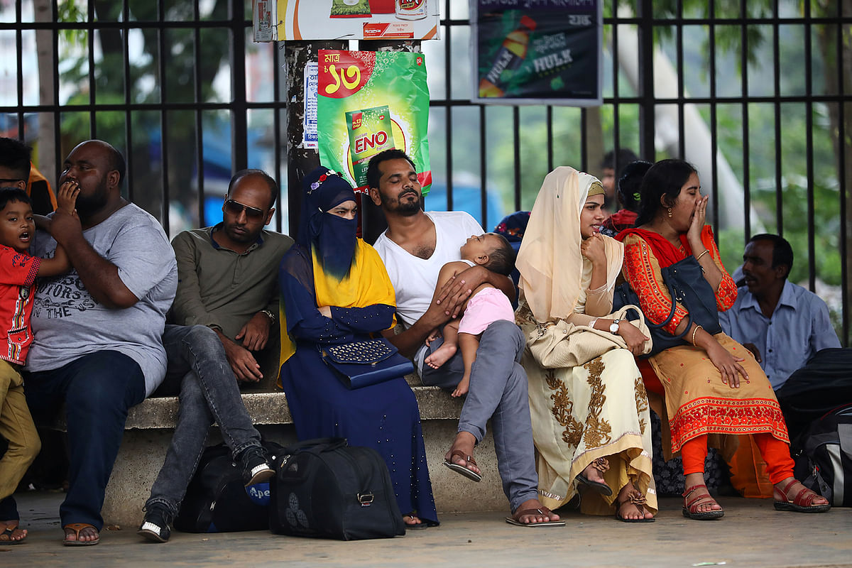 People wait for a train on a platform as they travel home to celebrate Eid al-Azha festival at a railway station in Dhaka, Bangladesh, on 10 August 2019. Photo: Reuters