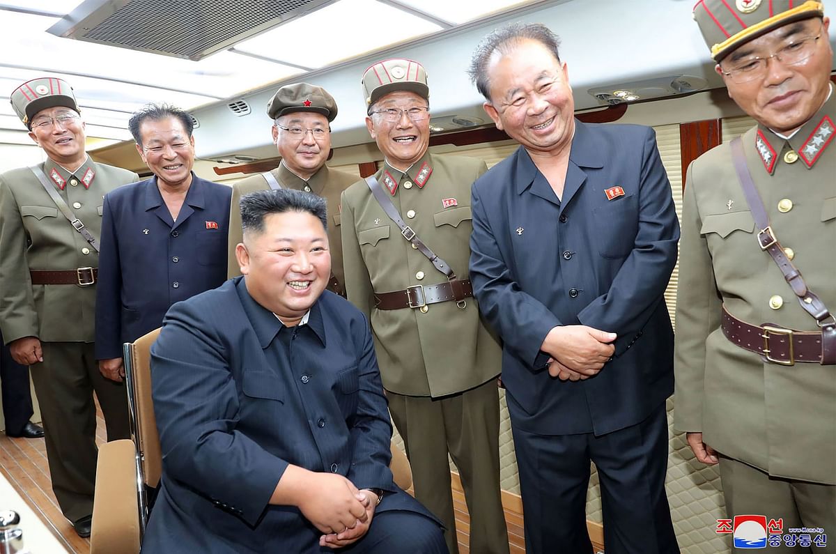 This early 10 August picture released from North Korea`s official Korean Central News Agency (KCNA) on 11 August shows North Korean leader Kim Jong Un (seated) supervising the test-fire of a new weapon at an undisclosed location. Photo: AFP