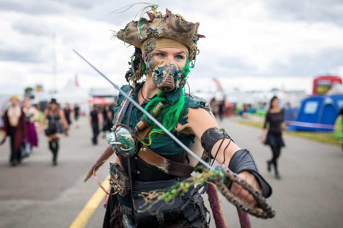 Sarah wears coloured contact lenses, a costume and a sabre as she poses on the grounds of the M`era Luna festival, one of Europe`s biggest events for the Gothic and black scene, on 10 August 2019 in Hildesheim, western Germany. Photo: AFP