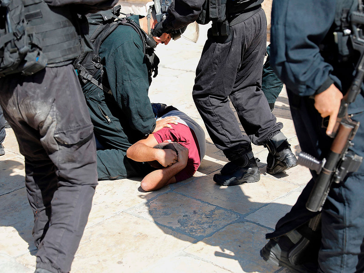 Israeli security forces detain a Palestinian at the al-Aqsa Mosque compound in the Old City of Jerusalem on 11 August as clashes broke out during the overlapping Jewish and Muslim holidays of Eid al-Adha and the Tisha B`av holiday. Photo: AFP