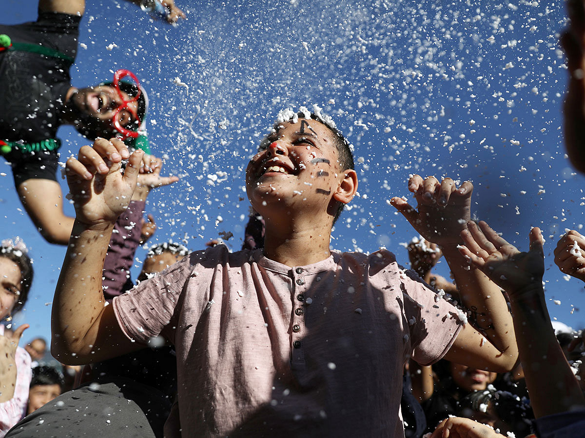 A youth smiles as foam covers him during celebrations marking the Muslim holiday of Eid al-Azha on the compound known to Muslims as Noble Sanctuary and to Jews as Temple Mount in Jerusalem`s Old City on 11 August 2019. Photo: Reuters