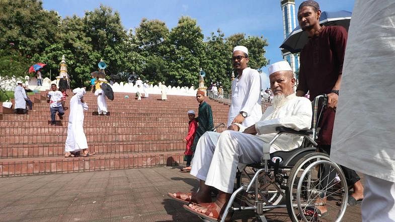 An elderly person being carried on a wheelchair to an Eid congregation in Sylhet on 12 August, 2019. Photo: Anis Mahmud