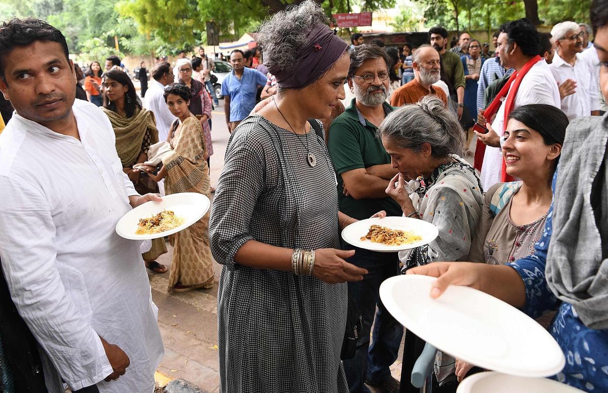 Booker Award winner Arundhati Roy (C) takes food with Kashmiri youth during a gathering to celebrate Eid al-Azha in New Delhi on 12 August 2019. Photo: AFP