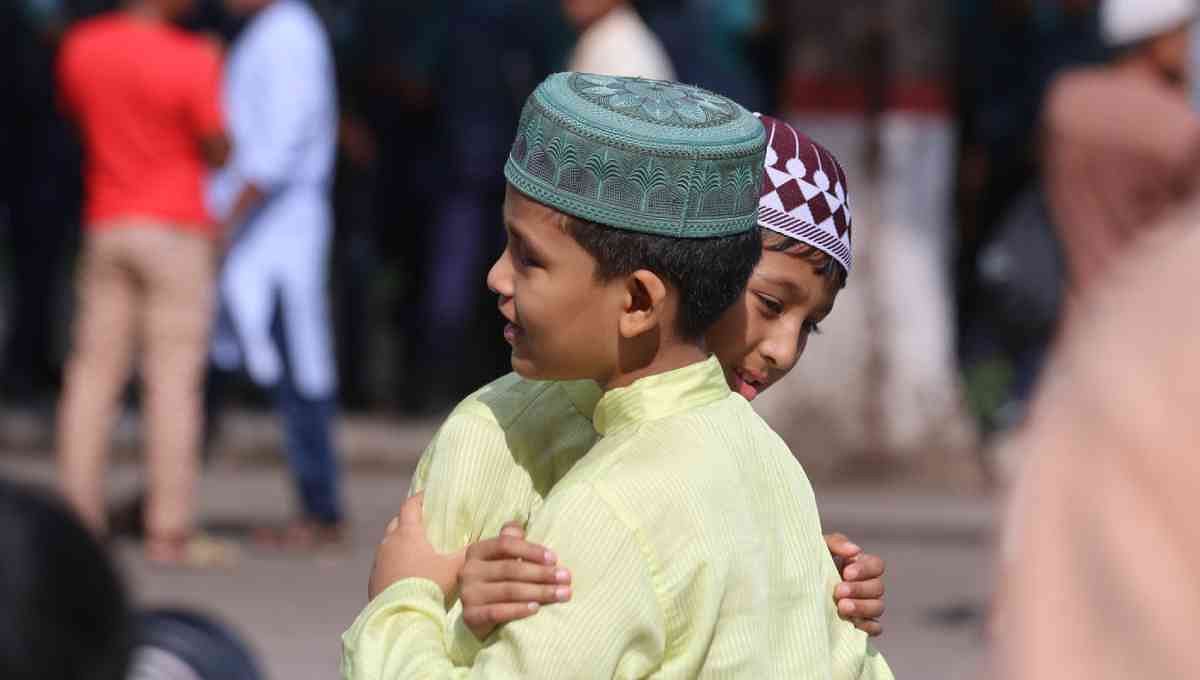 Two boys exchange greetings after Eid-ul-Azha prayers in Dhaka on 12 August, 2019. Photo: UNB