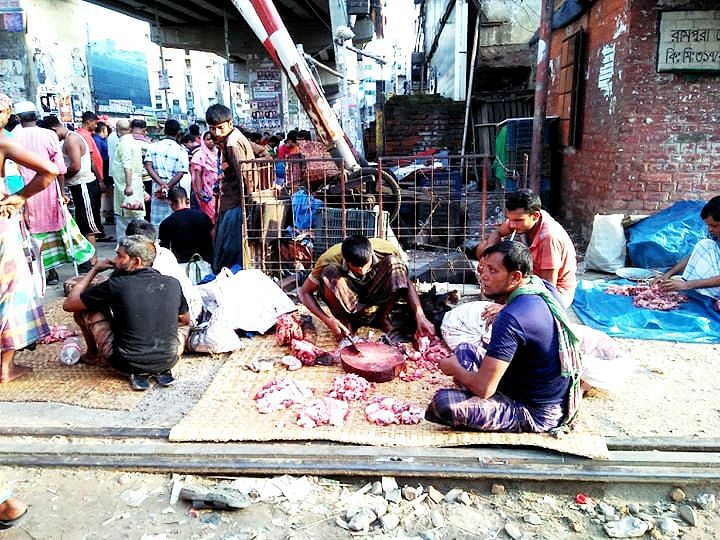 Three friends sell the beef they bouhgt from poor people at Malibagh railway crossing, Dhaka on Monday. Photo: UNB
