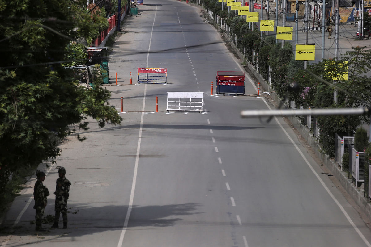 Indian security personal stand guard on a deserted road during restrictions on the Eid-al-Azha after the scrapping of the special constitutional status for Kashmir by the Indian government, in Srinagar, on 12 August 2019. Photo: Reuters