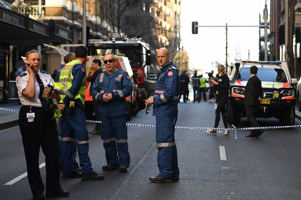 Police gather at the crime scene after a man stabbed a woman and attempted to stab others in central Sydney on 13 August before being pinned down by members of the public and detained by police. Photo: AFP