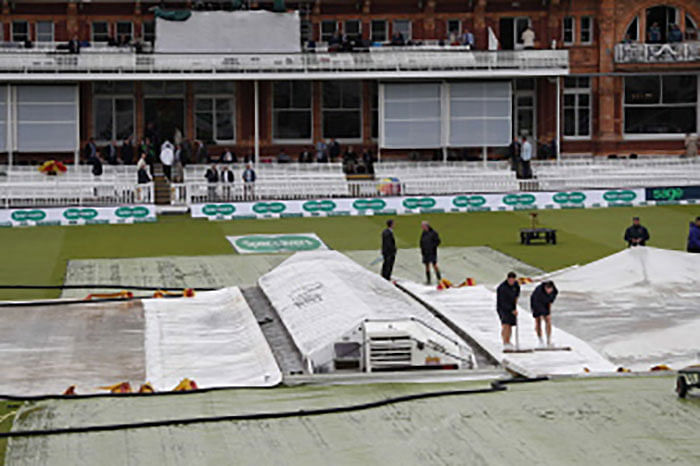 The covers protect the pitch from the rain ahead of play on the first day of the second Ashes cricket Test match between England and Australia at Lord`s Cricket Ground in London on Wednesday. Photo: AFP