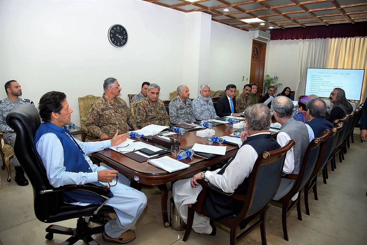 In this handout picture taken and released by Prime Minister Office (PMO) on 7 August 2019 Pakistan`s prime minister Imran Khan (L) chairs a National Security Committee meeting along with armed forces chiefs and other government officials in Islamabad. Photo: AFP