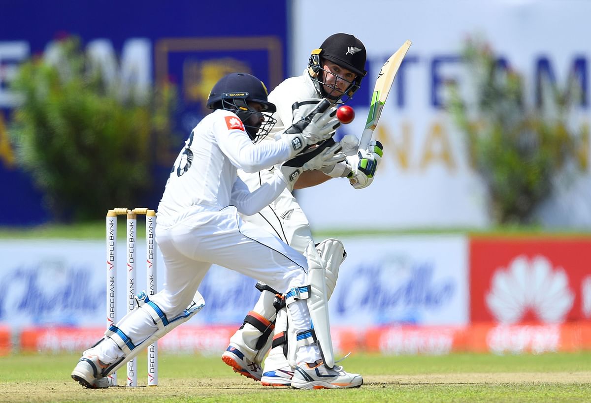 New Zealand cricketer Jeet Raval (R) plays a shot as Sri Lankan wicketkeeper Niroshan Dickwella looks on during the first day of the opening Test cricket match between Sri Lanka and New Zealand at the Galle International Cricket Stadium in Galle on 14 August 2019. Photo: AFP