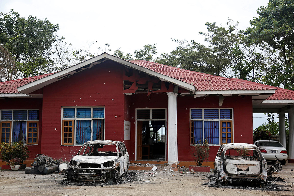 Burned vehicles stand in front of a destroyed narcotic police office in an insurgent attack on the Myanmar-China major trading route in Nawnghkio township, Shan state, Myanmar 15 August, 2019. Photo: Reuters