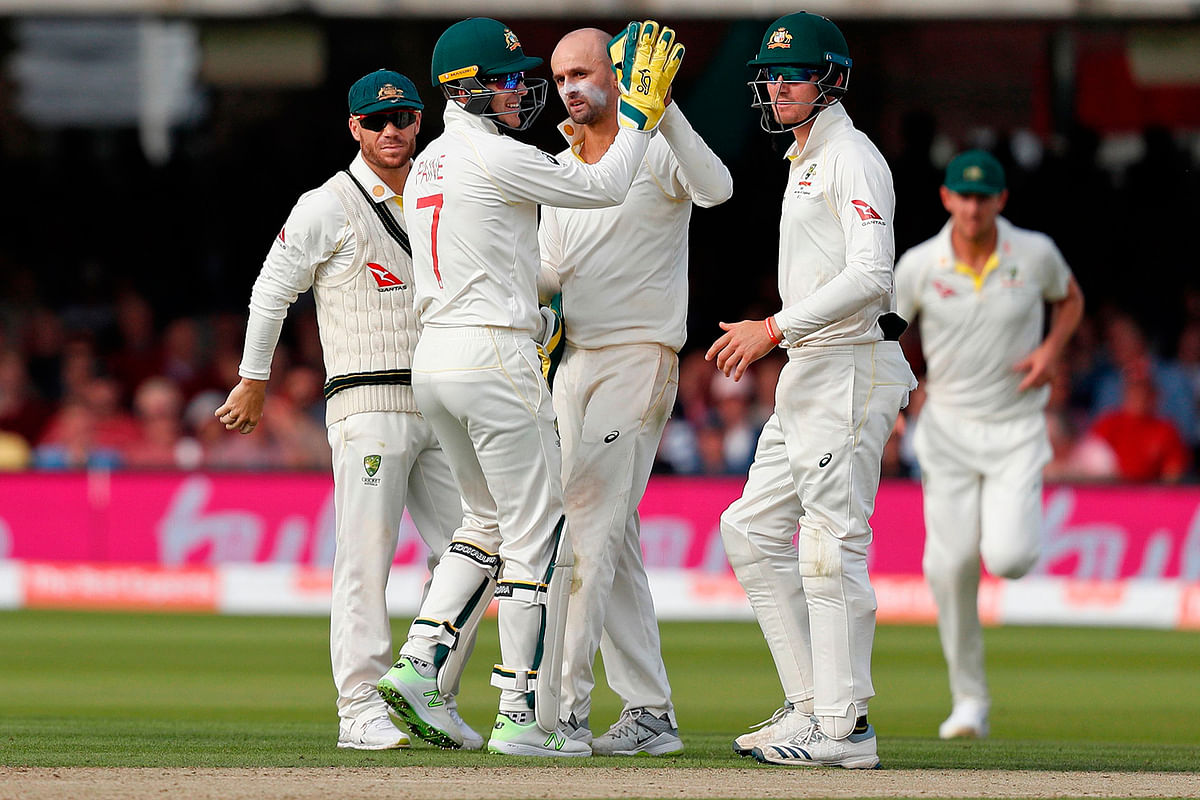 Australia`s Nathan Lyon (C) and Australia`s captain Tim Paine (2L) celebrate the wicket of England`s Stuart Broad for 11 runs on the second day of the second Ashes cricket Test match at Lord`s Cricket Ground in London on 15 August 2019. Photo: AFP