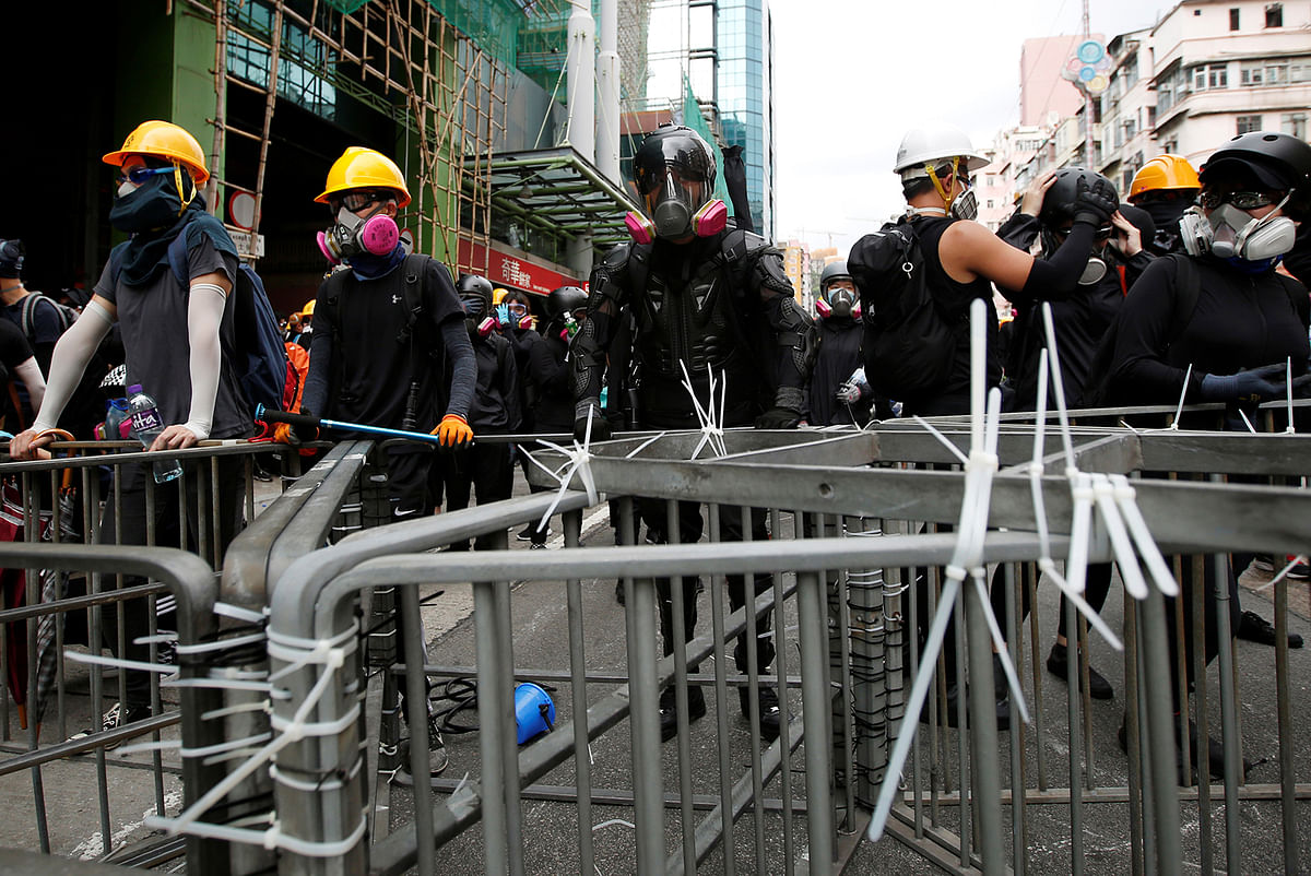 A protester nicknamed Ah Lung and other protesters hold the barricade near Sham Shui Po police station in Hong Kong, China on 11 August 2019. Photo: Reuters