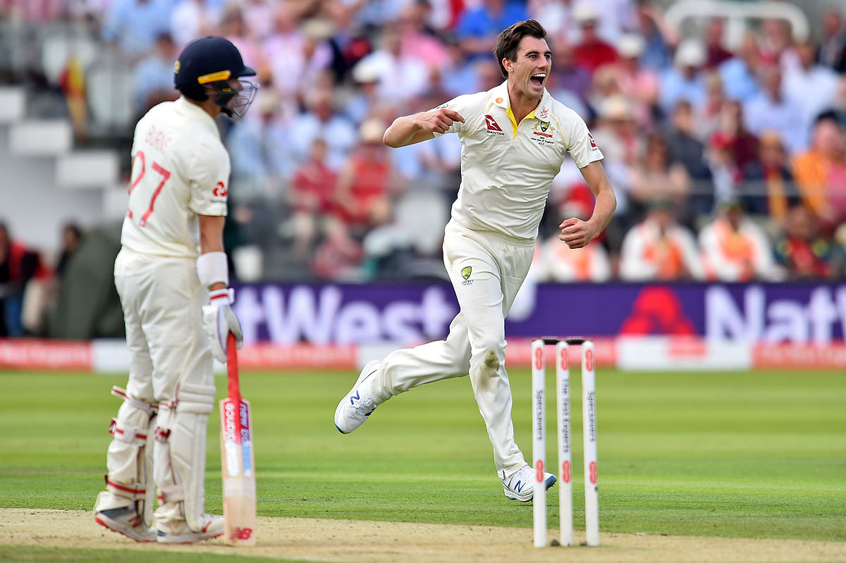 Australia`s Pat Cummins (R) celebrates the wicket of England`s Rory Burns (L) for 53 runs on the second day of the second Ashes cricket Test match at Lord`s Cricket Ground in London on 15 August 2019. Photo: AFP