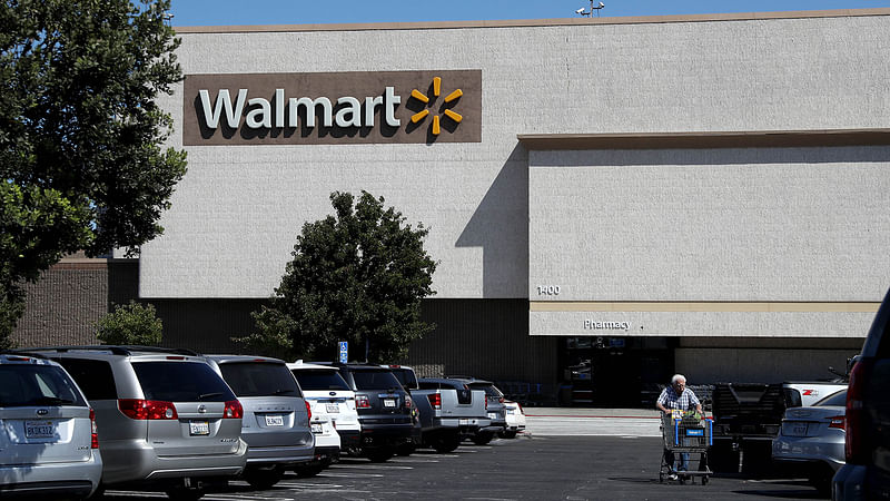 A customer pushes a shopping cart as he leaves a Walmart store on 15 August, 2019 in Richmond, California. Photo: AFP