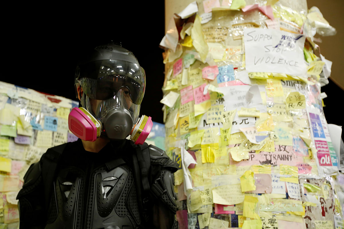A protester nicknamed Ah Lung poses before sticky note mosaics dubbed as `Lennon Wall` in Sha Tin district of Hong Kong, China on 12 August 2019. Photo: Reuters