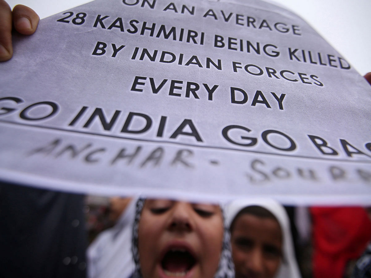 A Kashmiri girl displays a placard as she shouts slogans at a protest after Friday prayers during restrictions after the Indian government scrapped the special constitutional status for Kashmir, in Srinagar on 16 August 2019. Photo: Reuters