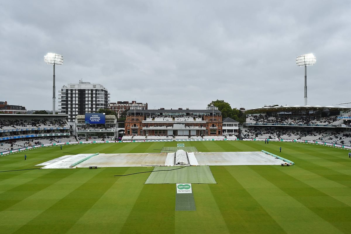 The covers protect the pitch from the rain during a delay in play on the third day of the second Ashes cricket Test match between England and Australia at Lord’s Cricket Ground in London on Friday. Photo: AFP